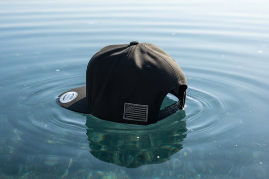Black cap with a flag patch on a white fluffy surface
